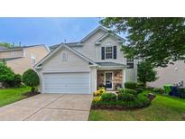 Charming home featuring well-manicured lawn, stone accents and a two-car garage at 5535 Spindlewood Ct, Durham, NC 27703