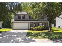 Charming two-story home featuring a gray exterior, red shutters, and a well-maintained front yard at 5940 Brambleton Ave, Raleigh, NC 27610