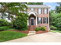 Charming two-story brick home featuring a landscaped front yard and classic architectural details at 601 Culpepper Ct, Durham, NC 27712