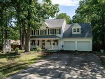 Charming two-story home featuring a welcoming front porch, a well-manicured lawn, and a two-car garage at 924 Magnolia Ridge Way, Fuquay Varina, NC 27526