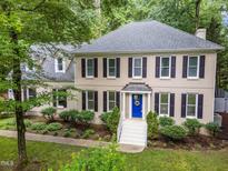 Charming two-story home featuring a blue door and well-maintained landscaping at 10317 Roadstead W Way, Raleigh, NC 27613