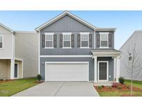 Charming two-story home with a two-car garage and well-maintained front lawn at 1168 Solace Way, Rolesville, NC 27571