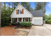 Charming cottage-style home with a welcoming front porch and well-maintained landscaping at 14 Donnibrook, Fuquay Varina, NC 27526