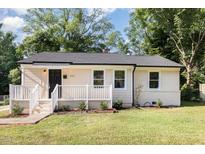 Charming single-story home with a well-maintained lawn and inviting front porch, displaying curb appeal at 2312 Shannon St, Raleigh, NC 27610