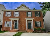 Brick two-story townhouse featuring classic architecture and well-maintained landscaping at 2459 Bay Harbor Dr, Raleigh, NC 27604