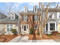 Charming brick townhome with a well-manicured front yard and inviting entrance at 2835 Bedfordshire Ct, Raleigh, NC 27604