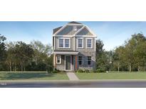 Charming two-story home featuring stone accents and a well-manicured lawn at 308 Canyon Spring Trl, Wake Forest, NC 27587