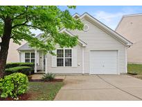 Charming single-story home featuring light siding, a one car garage, and a well-maintained front yard with manicured shrubs at 3108 Forrestal Dr, Durham, NC 27703