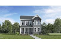 Charming two-story home with stone accents and a welcoming covered front porch at 312 Canyon Spring Trl, Wake Forest, NC 27587