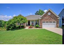 Charming one-story home boasting a beautifully landscaped front yard and stone accents at 372 Farnleigh Dr, Chapel Hill, NC 27517