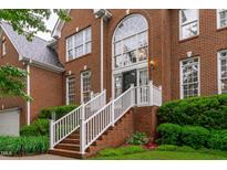 Brick home with an arched window above the front door and white railing at 408 Dairy Farm Dr, Hillsborough, NC 27278