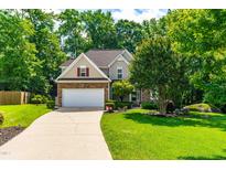 Charming two-story home with stone accents, mature landscaping, and a spacious driveway at 509 Fish Pond Ct, Rolesville, NC 27571