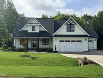 Charming two-story home with a well-manicured lawn and an attached two-car garage at 525 Allesandra Dr, Clayton, NC 27527