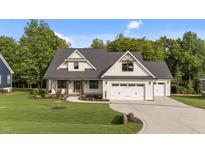 Charming home features a two-car garage, stone accents and a well-manicured lawn at 525 Allesandra Dr, Clayton, NC 27527