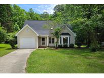 Charming single-Gathering home featuring a well-manicured front yard and attached one-car garage at 5401 Lower Creek Ct, Apex, NC 27539