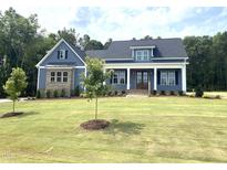 Charming new construction home features a beautifully landscaped lawn and inviting facade at 60 Stream View Way, Spring Hope, NC 27882