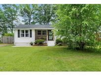 Charming single-story home featuring a cozy front porch and well-maintained lawn at 601 Longfellow St, Fuquay Varina, NC 27526