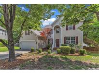 Charming two-story home featuring a well-maintained lawn and a classic design with red shutters at 8504 Delavan Cir, Raleigh, NC 27613