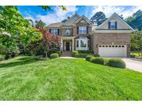 Beautiful two-story brick home featuring a well-manicured lawn and a two-car garage at 9 Sandhill Ln, Durham, NC 27713