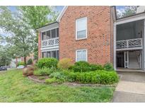 Charming brick condo featuring a cozy balcony and well-maintained landscaping at 1002 Kingswood Dr # A, Chapel Hill, NC 27517