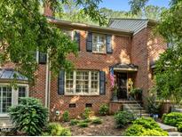 Charming brick two-story home with black shutters and manicured landscaping at 1112 Blenheim Dr, Raleigh, NC 27612
