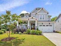 Charming two-story home featuring a well-manicured lawn and a two-car garage at 1148 Tringham Ct, Apex, NC 27502