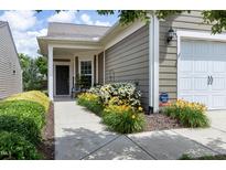 Charming home featuring a covered entryway, well-manicured landscaping and an attached one car garage at 118 Rosedale Creek Dr, Durham, NC 27703