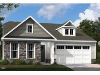 Charming home featuring stone accents, a two-car garage, and a welcoming entrance at 2010 Kapalua Way # 192, Durham, NC 27703