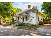 Charming home with white siding, inviting front porch, and well-manicured landscaping at 203 Brick St, Wake Forest, NC 27587
