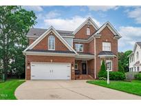 Beautiful brick two-story home with a two-car garage and well-manicured lawn at 2112 Tulare Ct, Raleigh, NC 27612