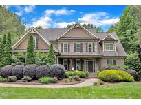 Beautiful two-story home with manicured landscaping, stone accents, and a welcoming front porch at 3007 Krogen Ct, Creedmoor, NC 27522