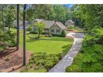 Charming two-story home with a well-manicured lawn, mature trees, and inviting curb appeal at 310 Cross Lake, Fuquay Varina, NC 27526
