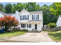 Charming two-story home featuring white siding, green shutters, and a well-manicured front lawn at 3634 Ranbir Dr, Durham, NC 27713