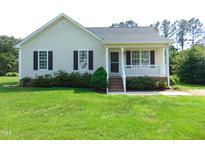 Charming one-story home with a well-manicured lawn and inviting front porch at 3803 Ridgewood Dr, Franklinton, NC 27525