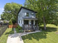 Charming two-story home features a modern design, landscaped yard, and inviting front porch at 409 E Lee St, Raleigh, NC 27601