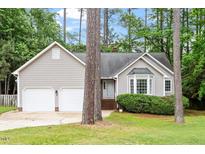 Charming single-story home with gray siding, mature trees, and well-maintained landscaping at 5 Wembley Ct, Durham, NC 27705