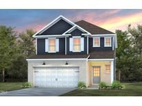 Charming two-story home featuring a brick facade, a two-car garage, and a cozy front entrance at 501 Providence Springs Ln, Fuquay Varina, NC 27526