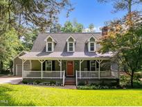 Charming home with a welcoming front porch, dormer windows, and well-manicured lawn at 5116 Knaresborough Rd, Raleigh, NC 27612