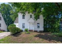 Charming two-story home featuring a classic white exterior and welcoming front porch at 5236 Turf Grass Ct, Raleigh, NC 27610