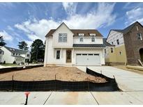 Charming new construction home with a white exterior, black trim and two-car garage at 6501 Burnette Flower Way, Raleigh, NC 27612