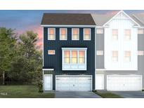 Beautiful townhouse featuring a two-car garage, multiple windows, and contemporary architectural style at 765 Larkspur Bowl Way, Apex, NC 27523