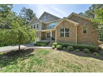 Charming two-story brick home with well-manicured landscaping and inviting curb appeal at 1009 Blue Larkspur Ave, Wake Forest, NC 27587