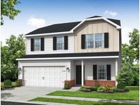 Charming two-story home with a two-car garage, black shutters, and a well-manicured lawn at 110 Hays St, Oxford, NC 27565