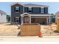 New construction two-story home featuring a welcoming front porch and a spacious two car garage at 1105 Landen Creek Ln, Zebulon, NC 27597
