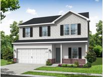 Charming two-story home featuring a two-car garage and manicured lawn at 114 Hays St, Oxford, NC 27565