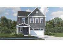 Charming two-story home with a gray exterior, stone accents, and an attached two-car garage at 1224 Coral Cay Bnd, Wake Forest, NC 27587