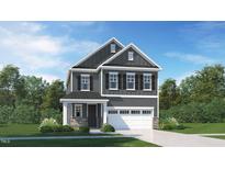 Charming two-story home with a manicured lawn, gray siding, and a two-car garage at 1228 Coral Cay Bnd, Wake Forest, NC 27587