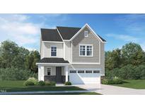 Charming two-story home featuring a two-car garage, stone accents, and covered entryway at 1232 Coral Cay Bnd, Wake Forest, NC 27587