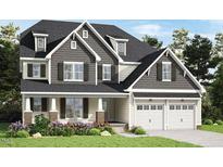 Charming two-story home featuring a two-car garage, dormer windows, and well-manicured landscaping at 1412 Auman Rd, Raleigh, NC 27603
