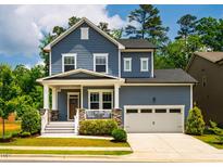 Charming two-story home boasts a welcoming front porch and attached two-car garage at 152 Chauncey Cir, Chapel Hill, NC 27516